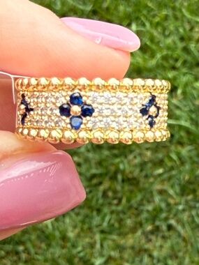 Gold ring with navy blue clover designs and CZ stone accents, size 7